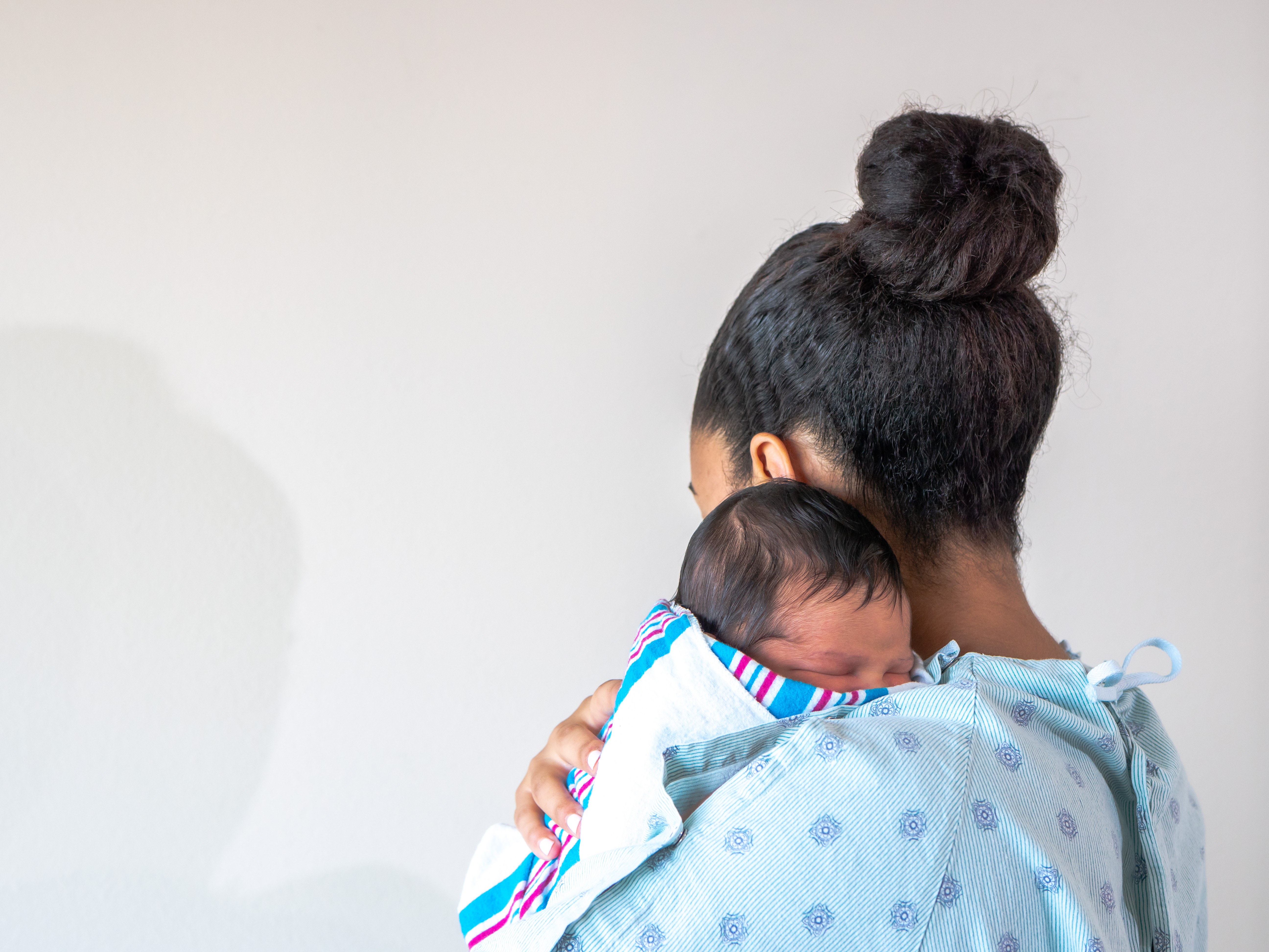 A new mom in the hospital with her newborn baby | Source: Shutterstock