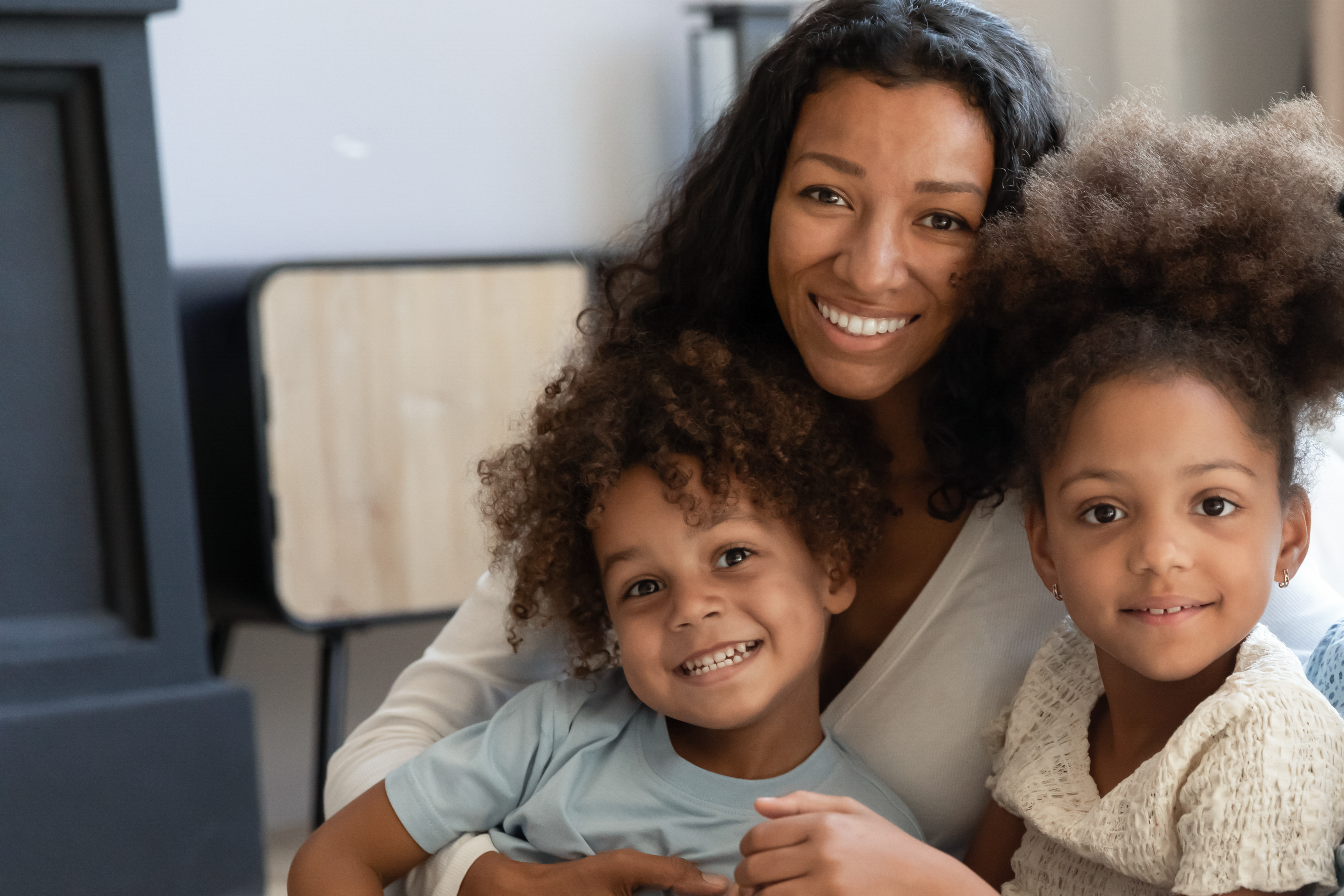 A mother smiling with her daughters | Source: Shutterstock