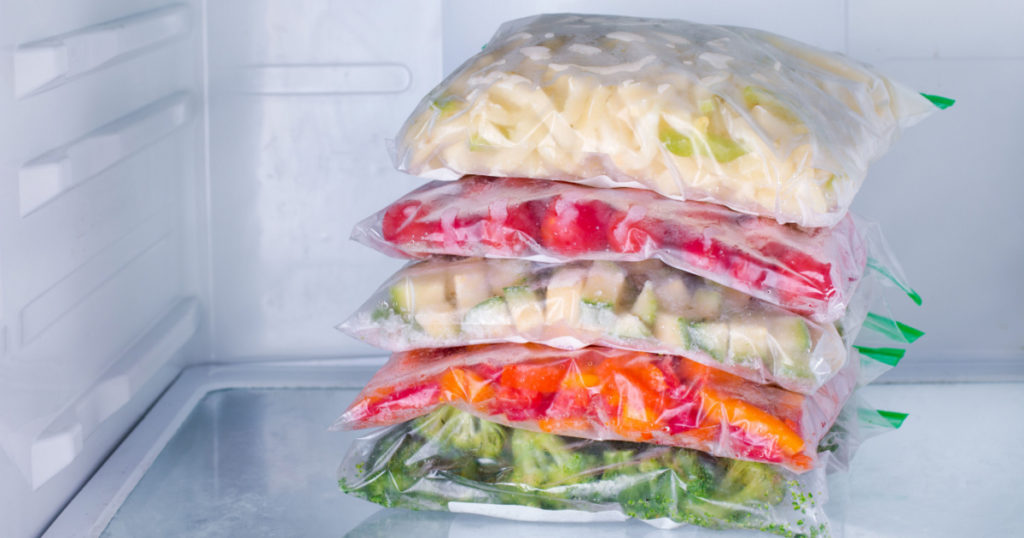 Frozen vegetables in bags in refrigerator 
