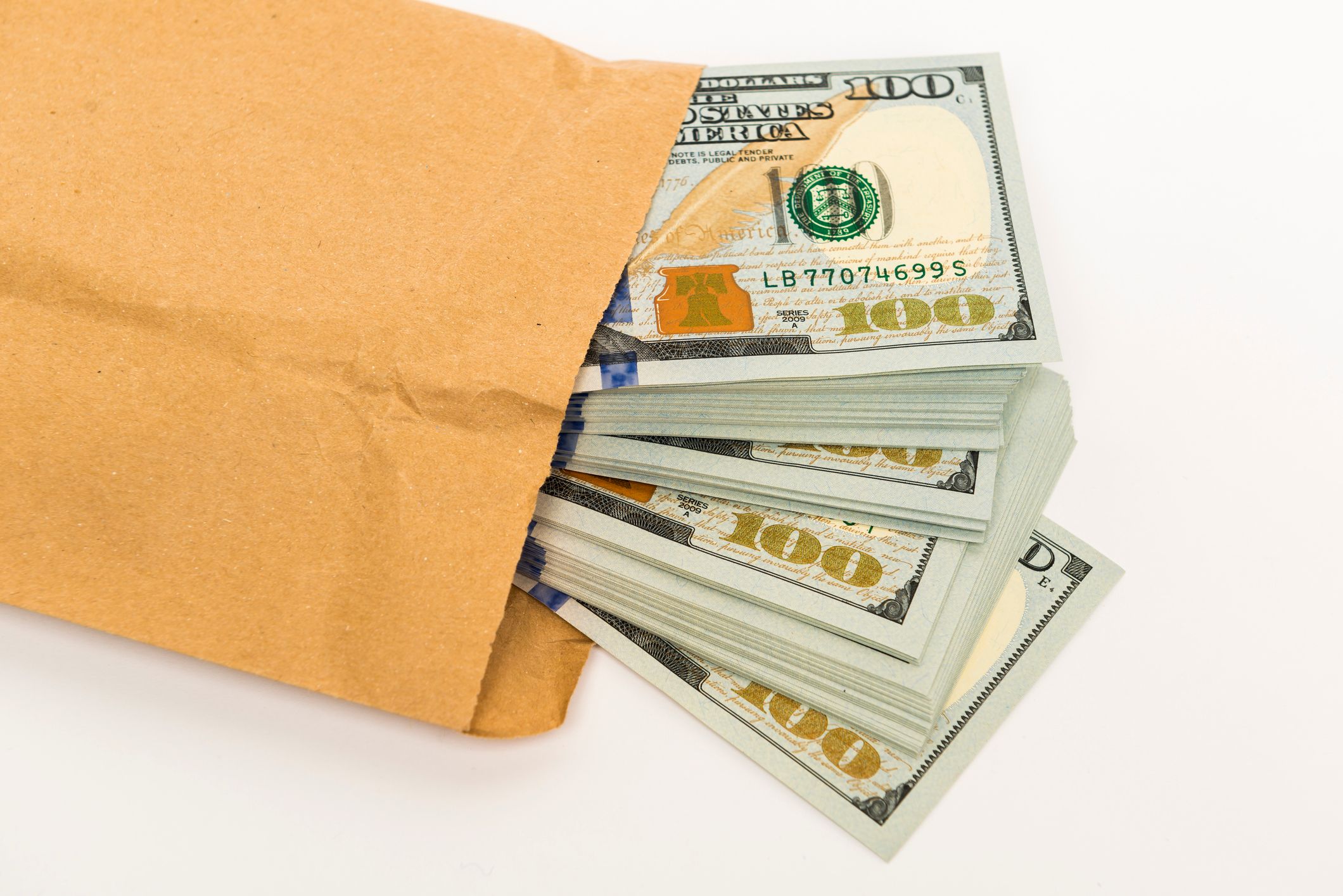 Several dollar bills in an envelope | Source: Getty Images
