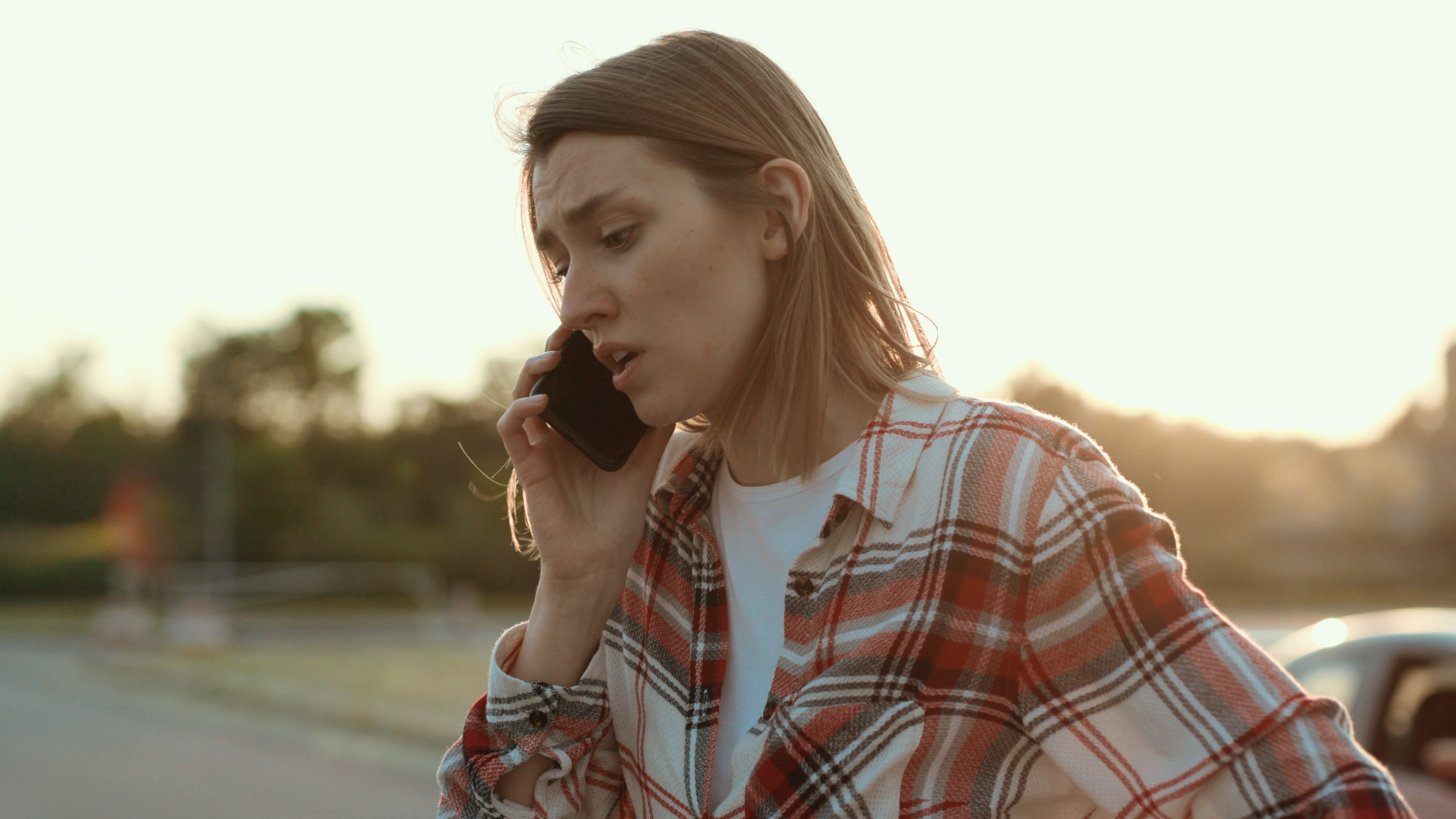 A woman on the phone looking worried | Shutterstock